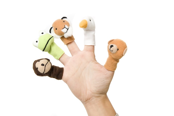 Child's hand with finger puppets on each finger